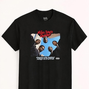 May include: A black short-sleeved t-shirt featuring a graphic print of the Miles Davis Quintet looking down from above. The red text reads Miles Davis Quintet and the white text reads STRAIGHT OUTTA COMPTON with a Parental Advisory label.