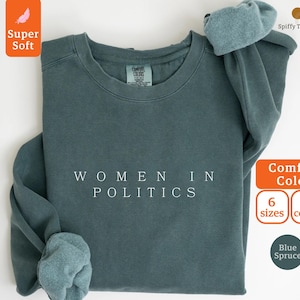 May include: A blue sweatshirt with the text "WOMEN IN POLITICS" printed in white on the front. The sweatshirt is available in 6 sizes and 8 colors.