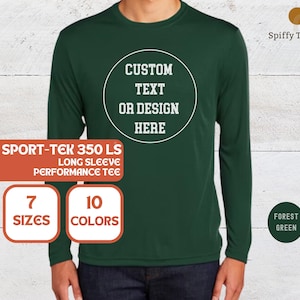 May include: A forest green long-sleeve performance t-shirt featuring a white circular graphic on the chest with the text CUSTOM TEXT OR DESIGN HERE. The shirt is labeled as a Sport-Tek 350 LS, available in 7 sizes and 10 colors, with Spiffy Touches branding.