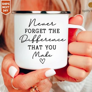 May include: White enamel mug with a black inscription that reads "Never forget the difference that you make" with a small heart symbol below the text.