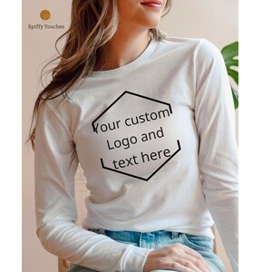May include: White long-sleeved t-shirt with a black hexagonal outline containing the text "Your custom Logo and text here".
