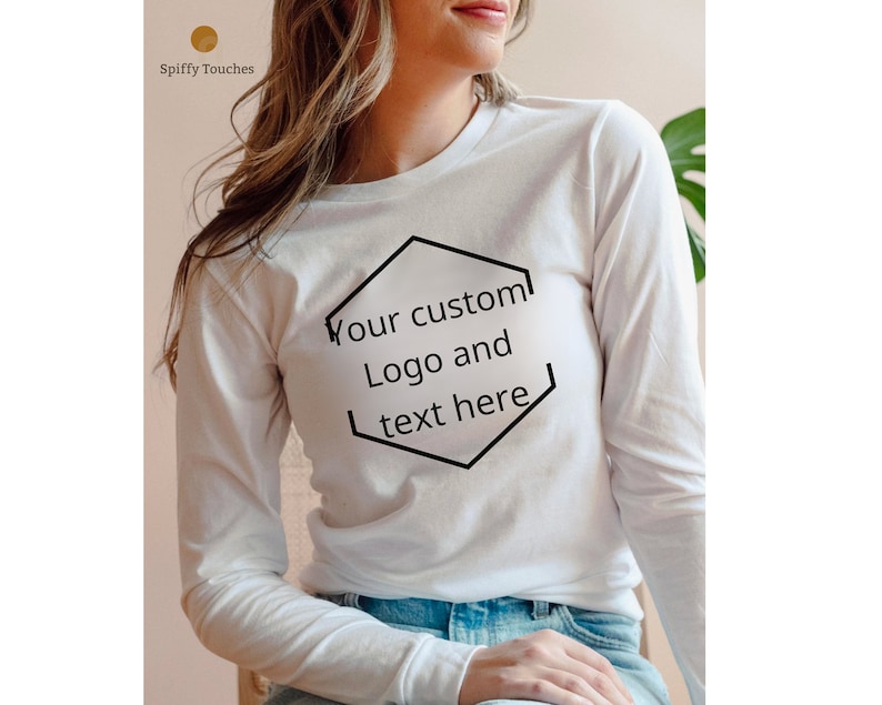 May include: White long-sleeved t-shirt with a black hexagonal outline containing the text "Your custom Logo and text here".
