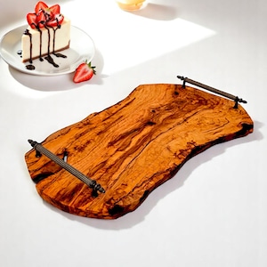 May include: A large, rustic wooden serving tray with two metal handles. The tray is made of natural wood with a rich brown colour and a unique grain pattern. The handles are made of metal with a dark finish and have a decorative design.
