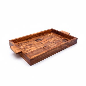 May include: A rectangular wooden serving tray with a mosaic pattern. The tray is made of light and dark brown wood pieces, with a raised edge and handles on each end. The tray is designed for serving food or drinks.