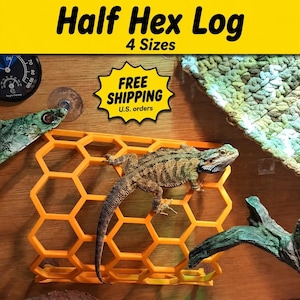 May include: An orange plastic half-hexagonal climbing structure for reptiles, featuring a honeycomb pattern. A bearded dragon lizard is positioned on top of the structure. The image includes text reading Half Hex Log and 4 Sizes.