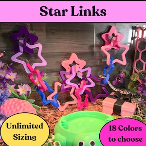 May include: A collection of interlocking star-shaped plastic links in purple, pink, and blue colors. The text Star Links is displayed at the top, with Unlimited Sizing and 18 Colors to choose printed in circular bubbles at the bottom of the image.