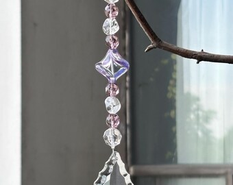 Atrapasol de araña morado y transparente