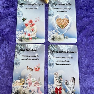 May include: Four tarot cards with French text and illustrations. The cards feature images of a couple, a heart with wings, a unicorn, and two women. A gold turtle figurine sits above the cards.