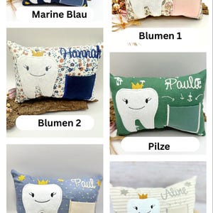 May include: A selection of tooth fairy pillows, each with a smiling tooth design and a pocket. The pillows come in various colours and patterns, including floral, striped, and solid colours. Each pillow has a name embroidered on it.