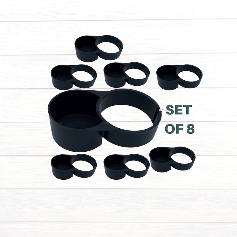 May include: Set of eight black plastic cup holders. The holders are designed to fit two cups or cans. The text "SET OF 8" is visible in the image.