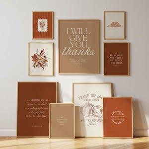 May include: A gallery wall set of nine framed prints in shades of terracotta, cream, and brown. The collection features botanical illustrations, pumpkin line art, and religious text including I WILL GIVE YOU THANKS and PRAISE THE LORD.