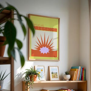 May include: A framed print with a yellow background and orange and purple sunburst design. The text "Pursue His Presence" is written in a retro font.