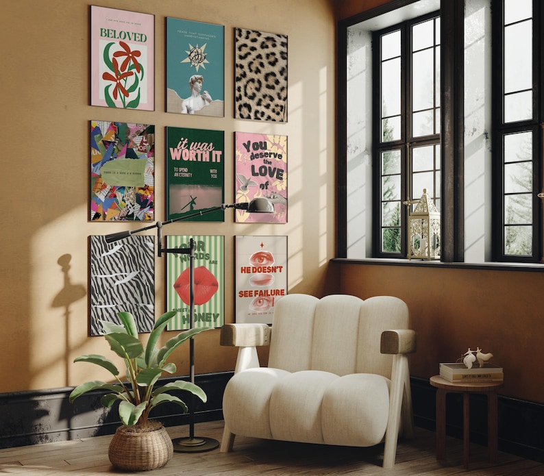 May include: A living room interior with a white armchair, a floor lamp, and a wall decorated with colorful posters. The posters feature various designs, including a zebra print, a red lip, and a quote about love.