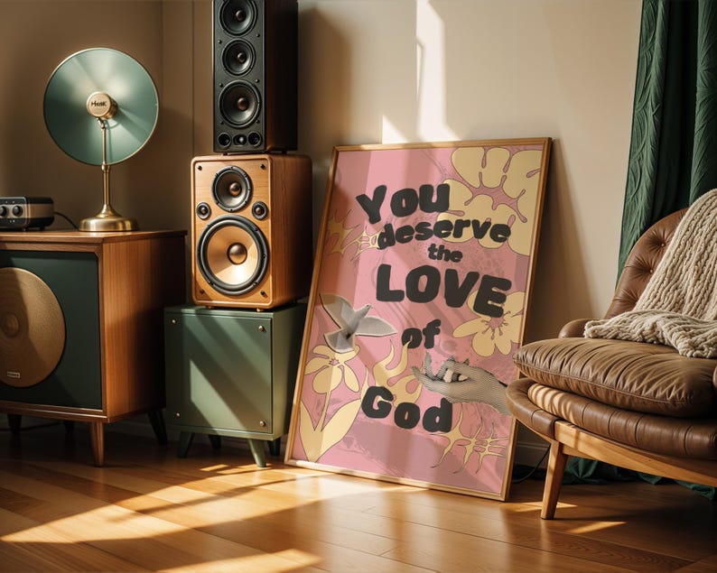 May include: Pink and yellow floral print poster with the text "You deserve the love of God" in black and white lettering.