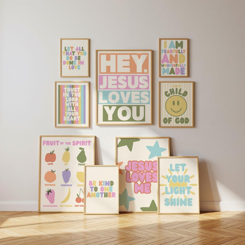 May include: A collection of nine framed wall art prints featuring pastel-colored typography and illustrations. The prints display religious phrases including Hey Jesus Loves You, Let All That You Do Be Done In Love, and Fruit Of The Spirit.