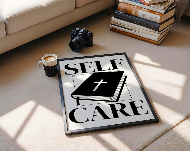 May include: Black and white print with the text "SELF CARE" in bold letters. A black book with a cross on the cover is in the centre of the print.