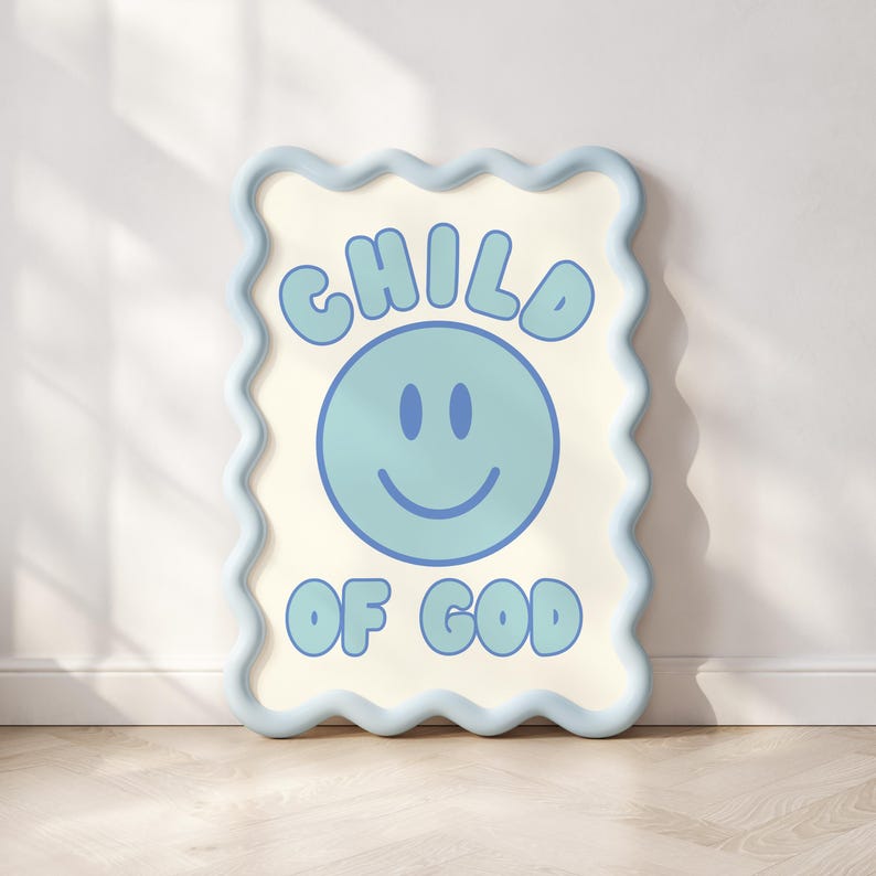 May include: A framed wall art piece with a light blue wavy border. The artwork features the words "CHILD OF GOD" in light blue, surrounding a light blue smiley face. The background is off-white.