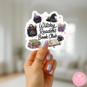May include: A sticker with a white outline featuring witchy-themed illustrations. It includes a cauldron, witch hat, books, a candle, and a coffee cup. The text reads "Witchy Readers Book Club". The sticker is held by a hand with iridescent nails.