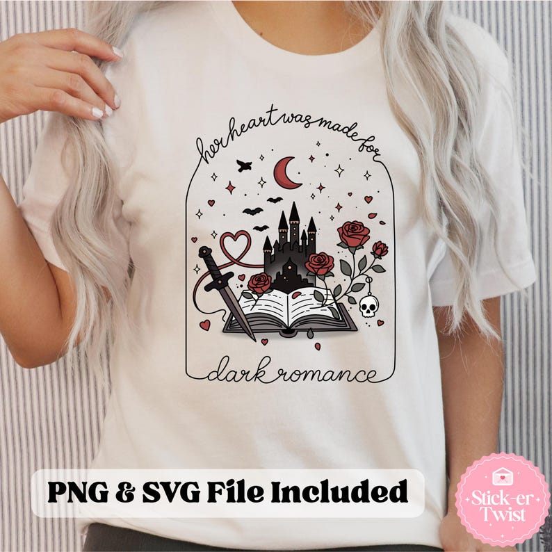 May include: White t-shirt with a graphic design featuring a castle, roses, a dagger, and the text "her heart was made for dark romance." The design includes a crescent moon, bats, and stars. The text "PNG & SVG File Included" is also present.
