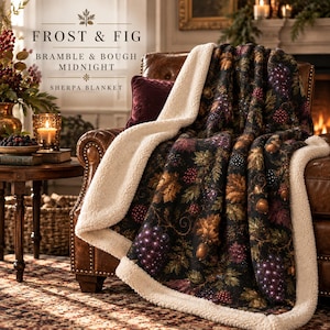May include: A Frost & Fig Bramble & Bough Midnight sherpa blanket featuring a dark black background with a botanical print of purple grapes, brown acorns, and autumn-colored leaves. The blanket has a thick, cream-colored textured sherpa lining.