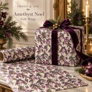May include: A square gift box wrapped in cream-colored paper featuring a pattern of purple ornaments, pine branches, and bows. The box is tied with a deep purple velvet ribbon and topped with a sprig of pine and gold berries. Text reads Frost & Fig Amethyst Noel Gift Wrap.