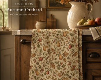 May include: A cream-coloured tea towel featuring a repeating pattern of autumn leaves, pears, and apples in shades of brown, green, and red. The text Frost & Fig Autumn Orchard Vintage Harvest Tea Towel is printed in the upper left corner of the image.