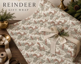 May include: Frost & Fig Reindeer Gift Wrap featuring a repeating pattern of reindeer and evergreen trees in muted green and rust tones on a cream background. A gift box is wrapped in this paper with a beige linen ribbon and a small pine sprig.