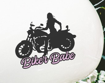 May include: Black silhouette of a person riding a motorcycle with the text "Biker Babe" in pink lettering.