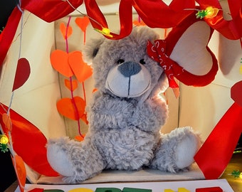 Grey teddy with heart balloon for adoption