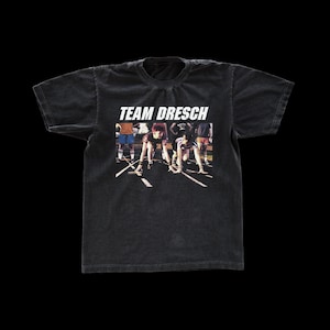 May include: Black t-shirt with a vintage-style graphic of a group of people in a race, with the text "TEAM DRESCH" above the image.