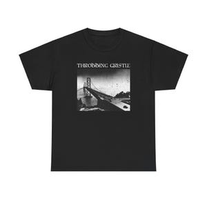 May include: Black t-shirt with a white graphic of a bridge and the text "Throbbing Gristle" printed on the front.