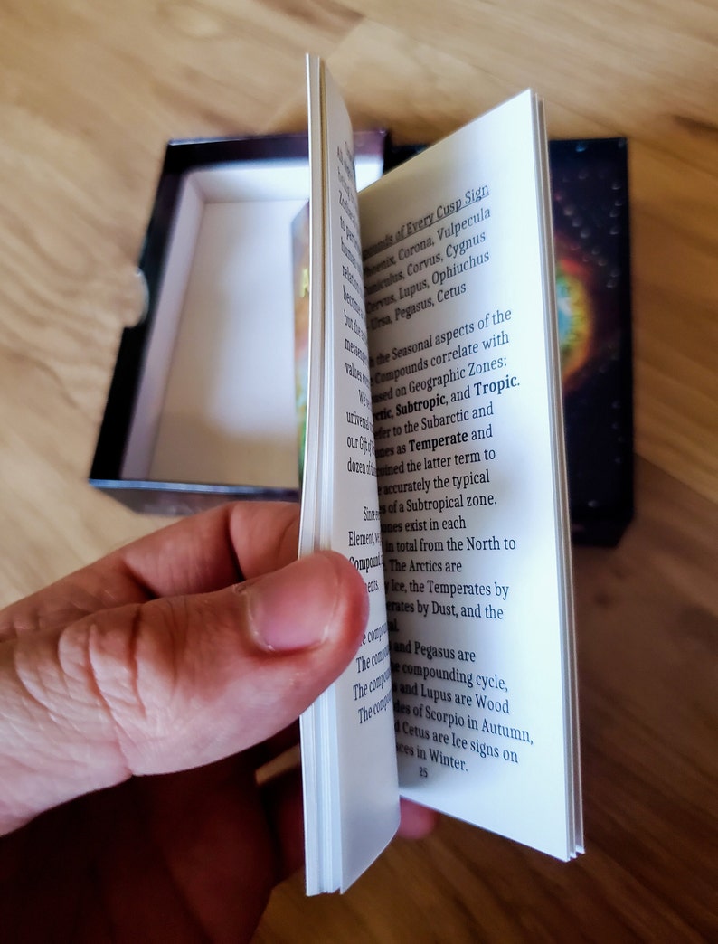 Flipping through pages of the Astal Atlas Guide Booklet.