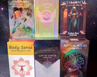 May include: A collection of oracle and tarot decks, including "Stellarfable Oracle Deck," "Heartsong Tarot," and "Altar Oracle Statue Deck." The decks feature colorful artwork and text, with titles and author names visible. The decks are displayed on a clear shelf against a starry background.