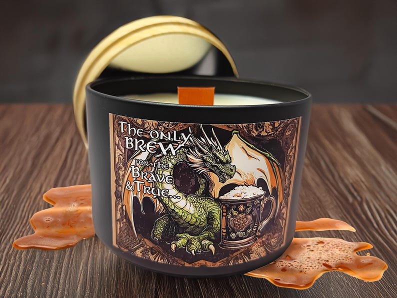 May include: A black candle jar with a dragon and a beer mug design. The label reads "The Only Brew For the Brave & True".