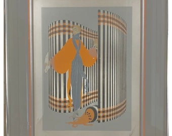 May include: A framed print of a woman in a colourful dress standing in front of a striped screen. The woman is wearing a scarf and holding a fan. The print is on a grey background.