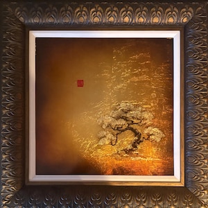 May include: An abstract painting of a tree with gold and brown tones. The tree is in the lower right corner, with a red square in the upper left. The painting is in a decorative brown frame.