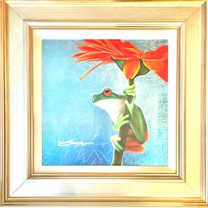 May include: A framed painting of a green tree frog with red eyes clinging to a stem supporting a large orange flower. The background is a light blue with a textured appearance. The frame is gold.