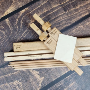 May include: A set of wooden embroidery hoops with a natural finish. The hoops are 60 cm in diameter and are made in Poland. The packaging includes a small piece of white fabric and a set of wooden needles.