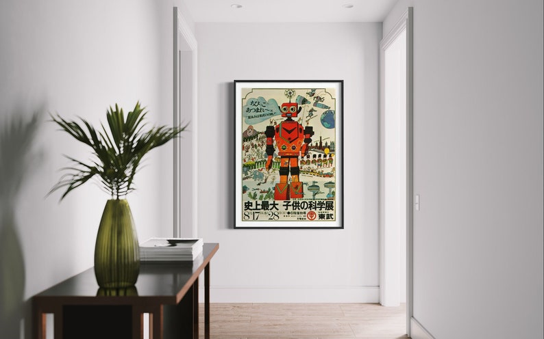 May include: A vintage Japanese poster advertising a children's science museum. The poster features a red robot with a large head and a bright yellow background. The text on the poster reads "History's Greatest Children's Science Museum".