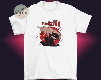 May include: White t-shirt with a black and red illustration of Godzilla with the word "godzilla" printed in red above the illustration.