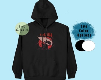 May include: Black hooded sweatshirt with a red and white Godzilla graphic and the text "Godzilla" in red.