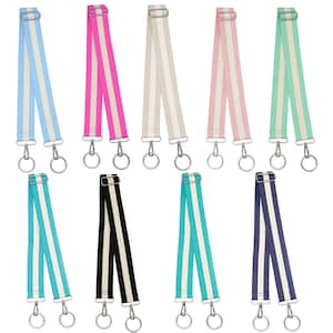 May include: A collection of colorful, striped bag straps in various shades including blue, pink, beige, mint green, turquoise, black, and navy. Each strap features a silver-toned metal clasp and ring for attachment. The straps are designed with a vertical stripe pattern.