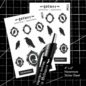 May include: A 4" x 6" Nevermore sticker sheet featuring black silhouettes of ravens, ornate frames, and cameo portraits. The sheet includes the text "forevermore" and "nevermore". A black pen is in the foreground.
