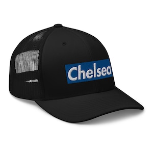 May include: Black trucker hat with a blue and white box that says "Chelsea" on it.
