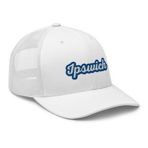 May include: White trucker hat with a mesh back and a curved brim. The word "Ipswich" is embroidered in a blue script font with a white outline on the front of the hat.