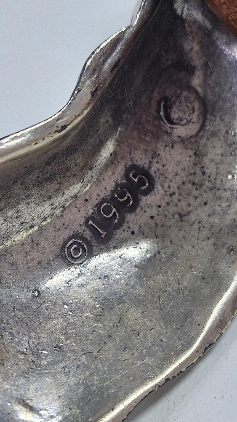 May include: A white ceramic mug with a black handle and the text "But First, Coffee" in a black, bold font. The mug is on a white surface. The mug is approximately 4 inches tall.