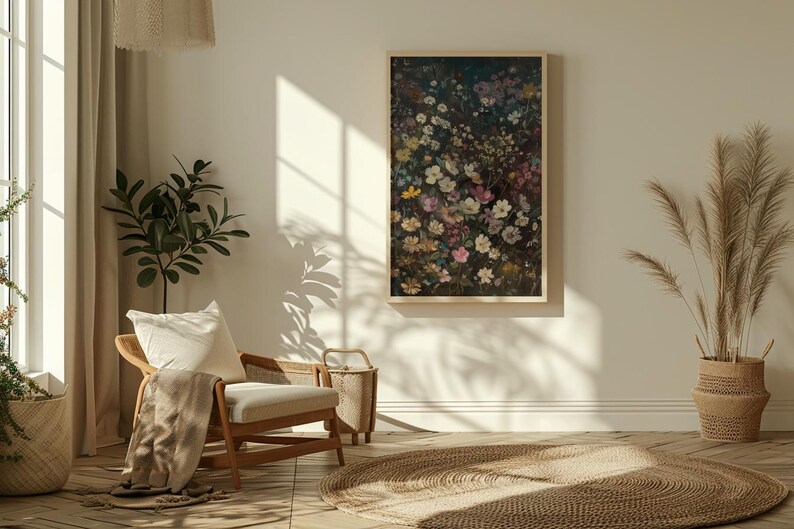 May include: A framed print of a floral arrangement featuring a variety of pink, white, and purple flowers on a dark background. The print is hanging on a white wall in a living room setting.