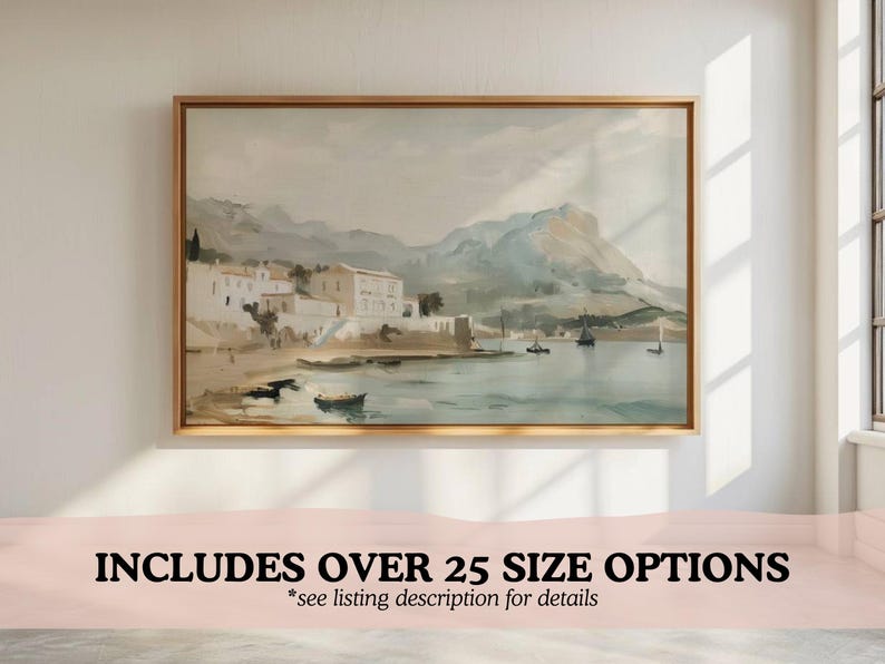 May include: A watercolor painting of a coastal town with white buildings and boats in the water. The painting is framed in a light wood frame.
