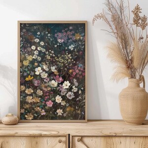 May include: A framed print of a floral arrangement featuring a variety of flowers in shades of pink, white, and yellow against a dark background.