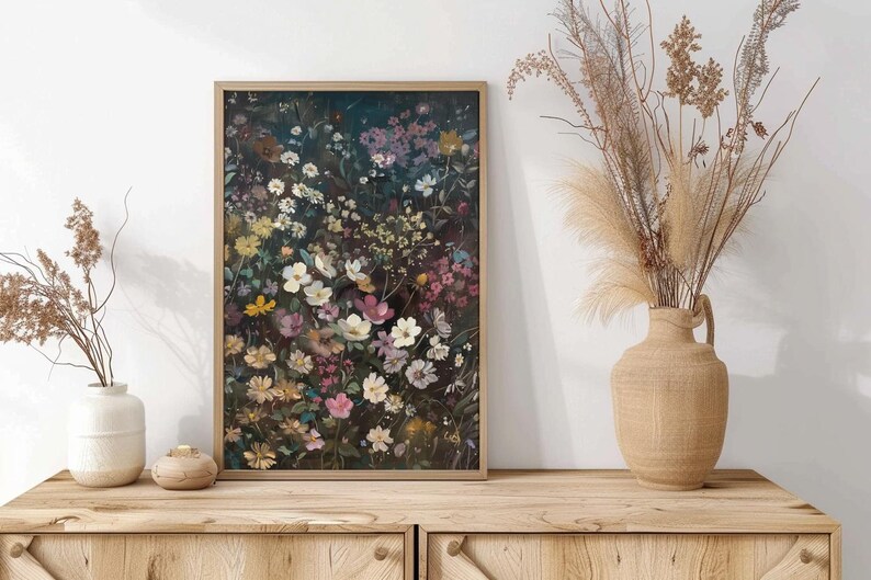 May include: A framed print of a floral arrangement featuring a variety of flowers in shades of pink, white, and yellow against a dark background.